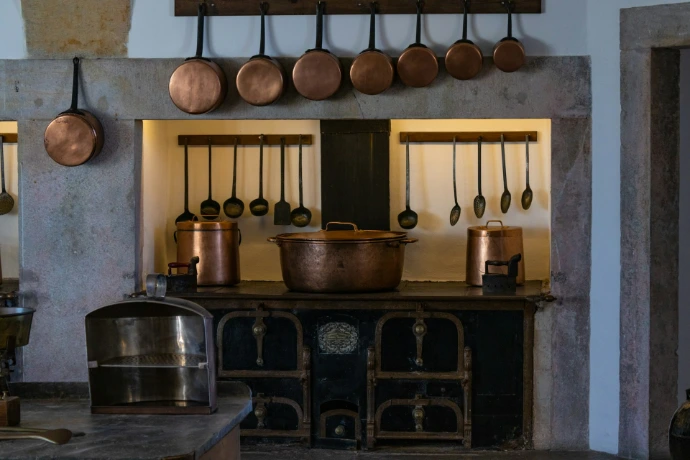 a kitchen with pots and pans hanging on the wall